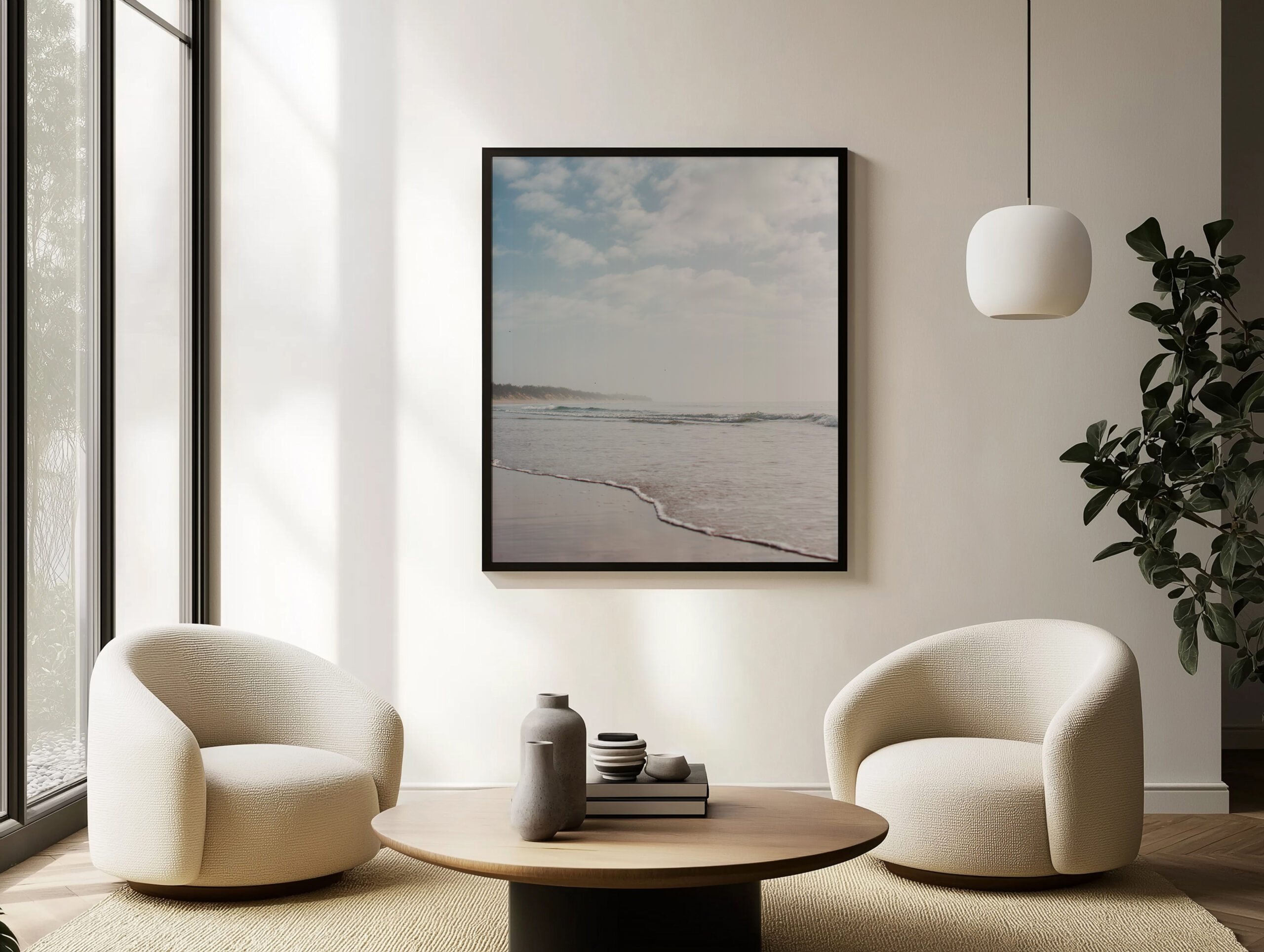 Black framed artwork displayed above two waiting chairs in a modern hotel seating area.