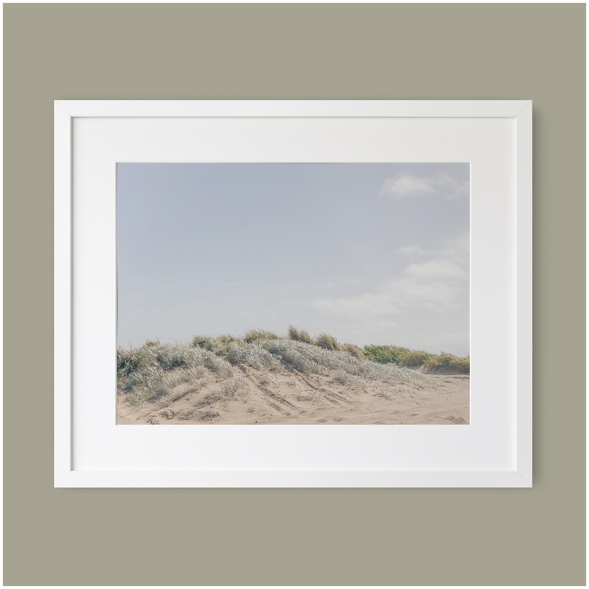beach themed wall art in a simple white frame.